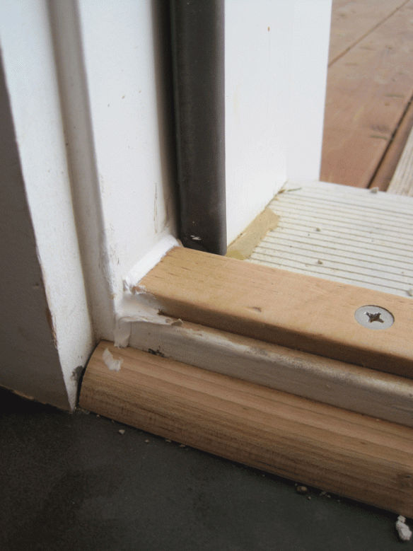 I caulked the plate after adjusting it vertically to fit snugly against the door's lower seal.