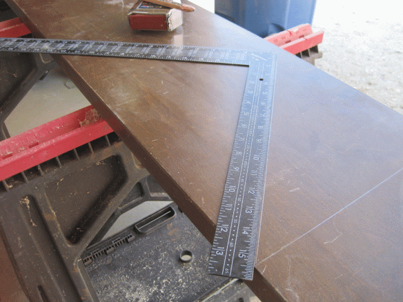 Lining up the 45 degree cut on the hollow bi-fold door. Measure 12 inches up on both sides of the square along the same edge.