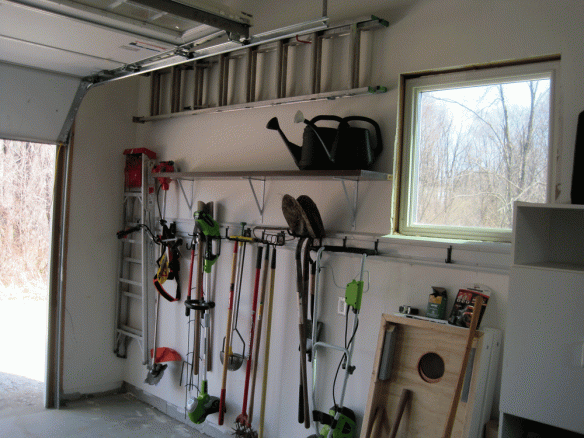In addition to the Gladiator track I added another hollow bi-fold door shelf and even hung up the extension ladder way up high, out of the way.