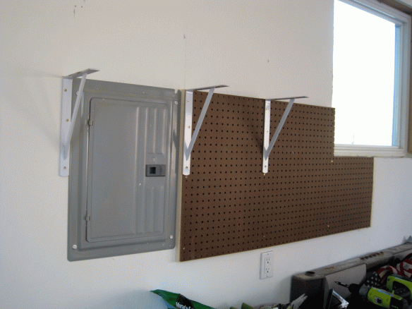 I mounted the brackets over the pegboard and drywall, where the wall studs are.
